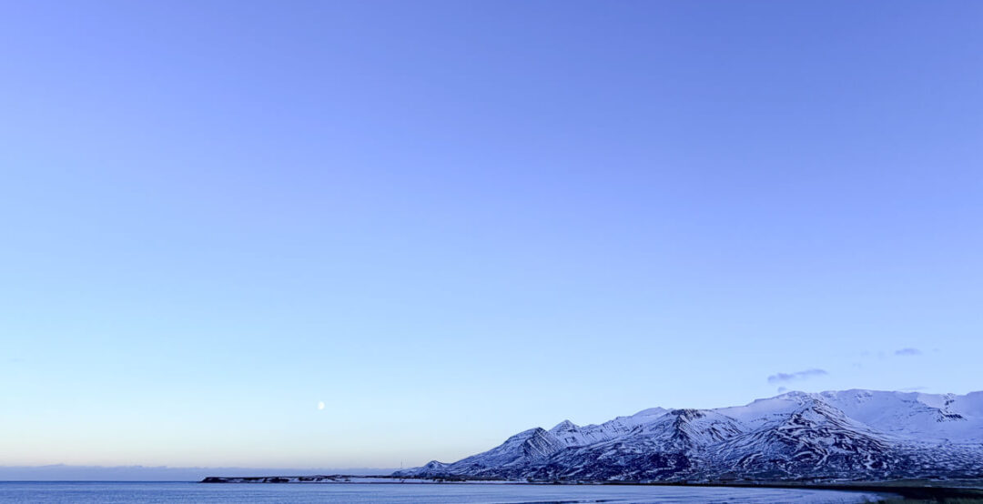 Snowy mountains and coastline by the sea in winter in North Iceland