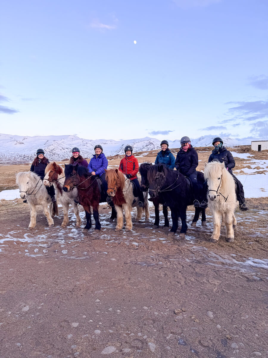 Women on horseback in snowy landscapes in North Iceland during a winter holiday