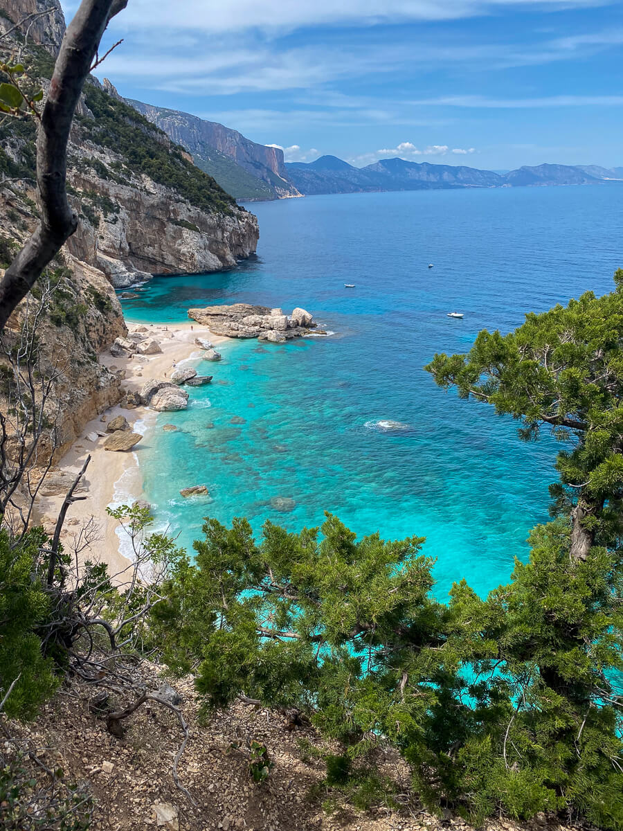 Clifftop hiking viewpoint over turquoise coves and sea cliffs on Sardinia’s coast