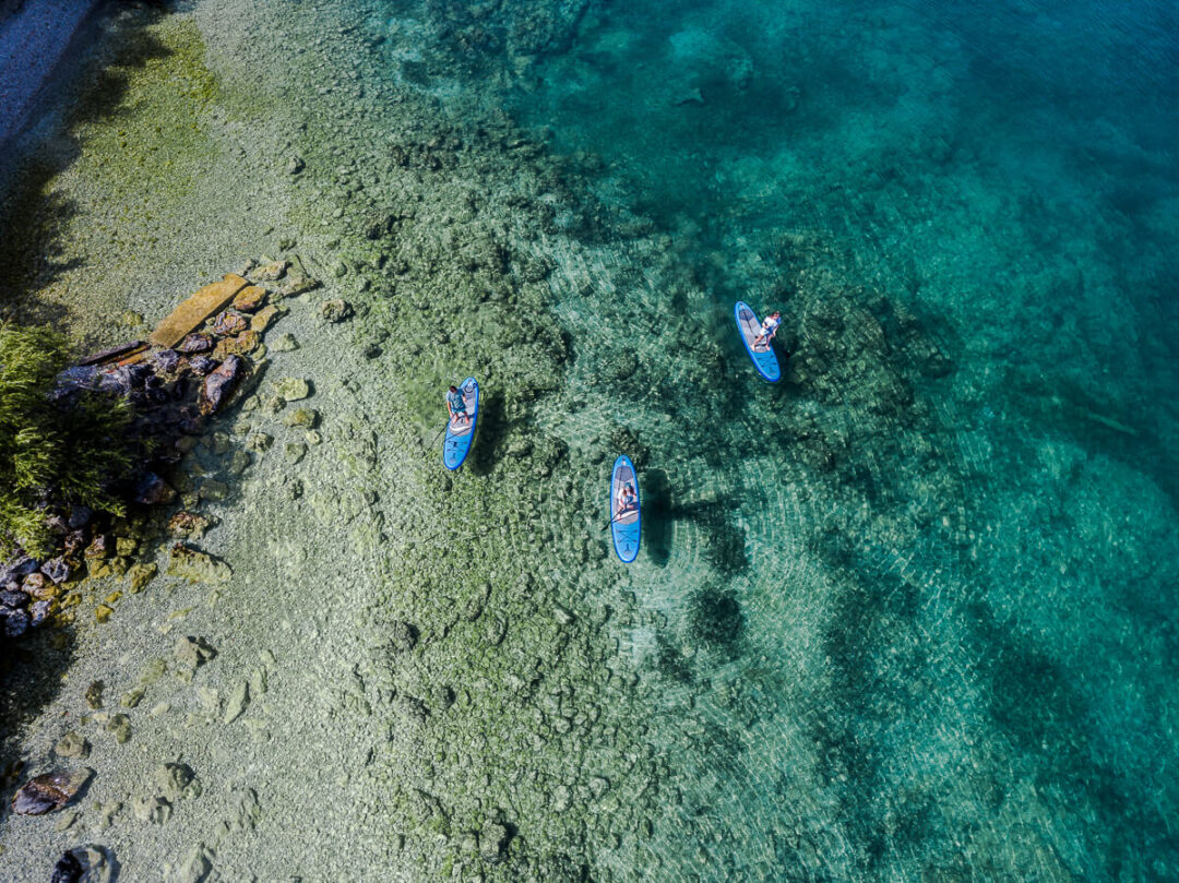 Paddleboarders on the clear water of Lake Ohrid, North Macedonia during a multi-activity holiday.