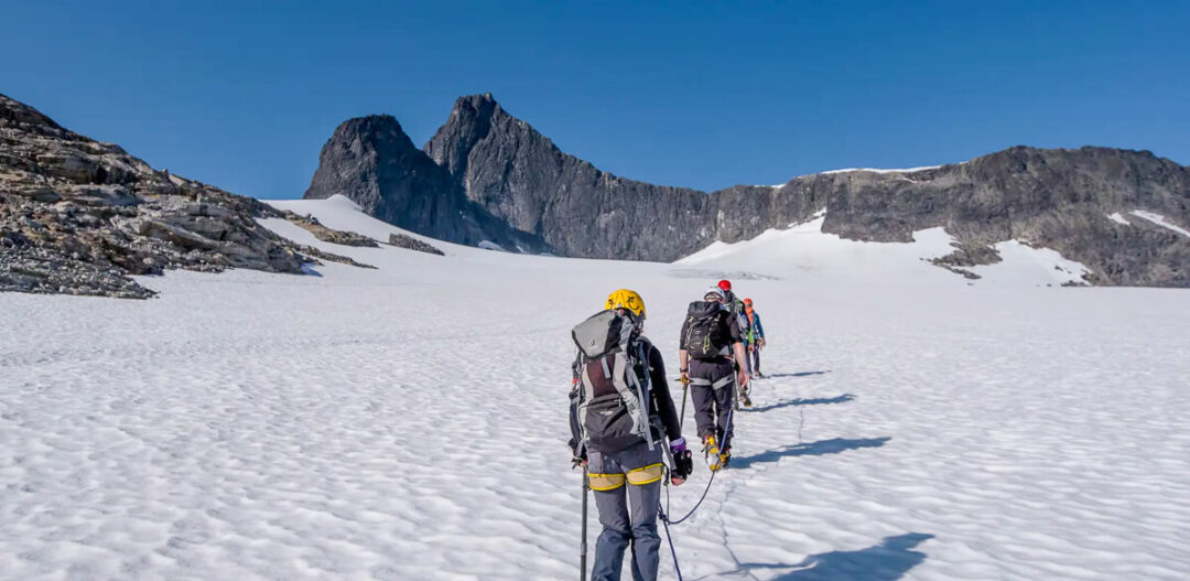 Women mountaineering on a snowy mountain glacier in Jotunheimen National Park