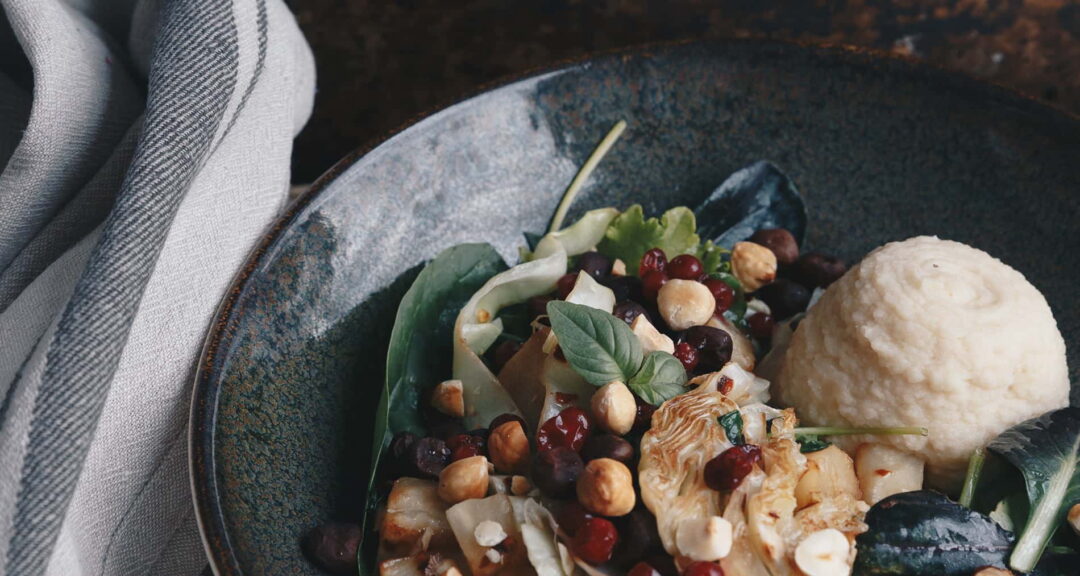 Vegetable and bean salad with mushrooms and bread served in a bowl