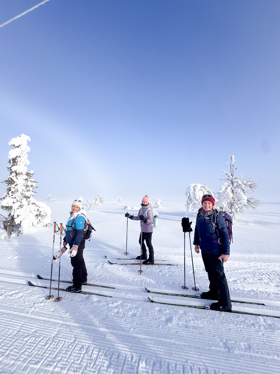 Women cross-country skiing on snowy tracks in a winter landscape