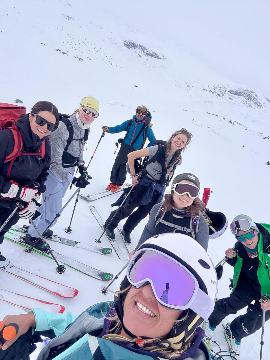Women ski touring on snowy mountain slopes, taking a selfie with skis and poles in Norway