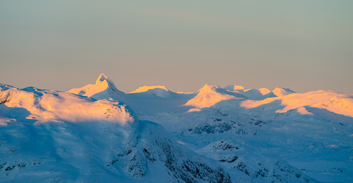 Snowy mountain peaks at sunrise, winter landscape for ski touring