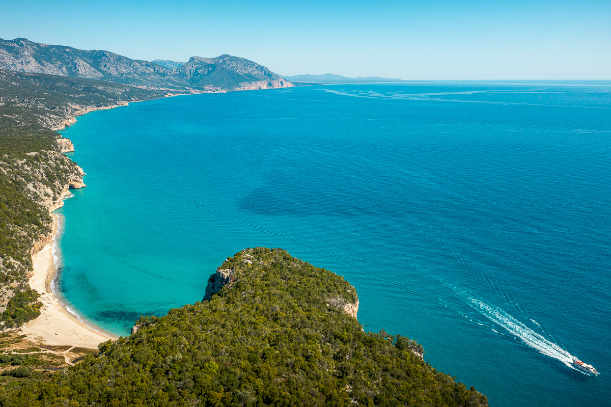 Coastal seascape from above on Sardinia’s east coast, turquoise bay and headland.