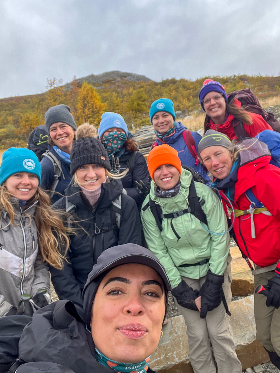 Women hikers smiling on a mountain trail during an outdoor adventure holiday in Europe