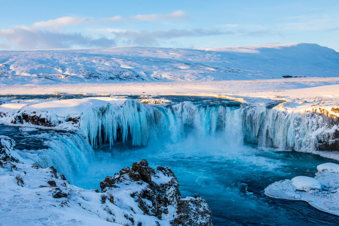 godafoss waterfall in Iceland with ice and snow