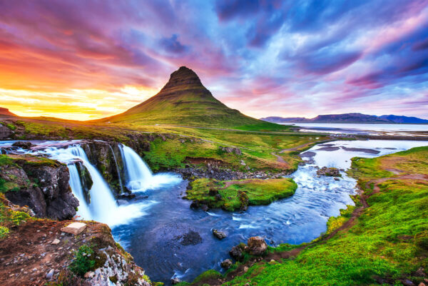 waterfall and mountain landscape at sunset in Iceland