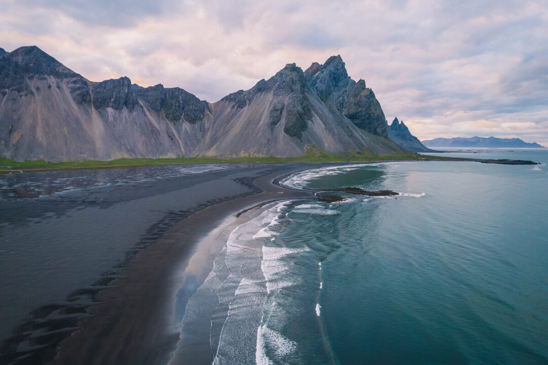 black sand beach with mountains in Iceland