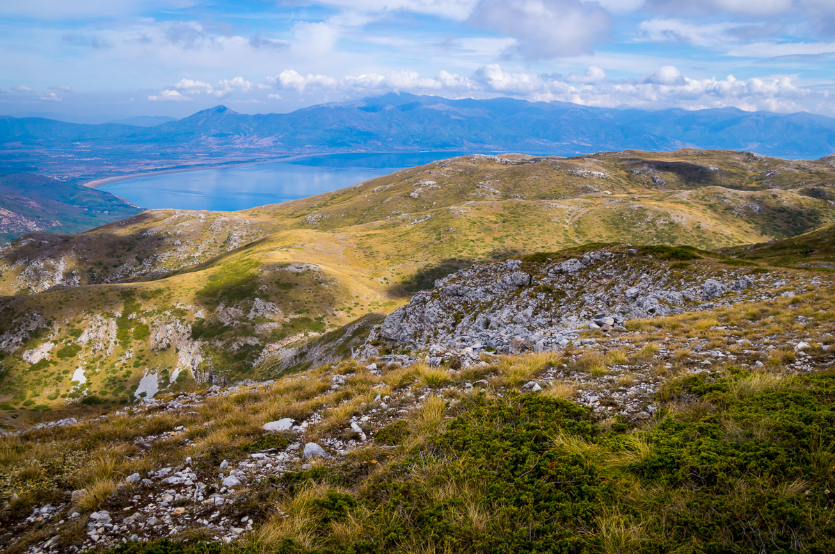 Mountain ridge landscape with sweeping views over a distant lake and valley