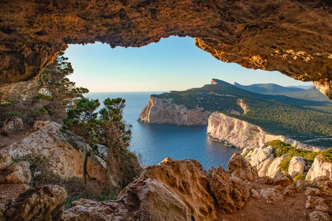 Cave view overlooking serene coastline in Sardinia