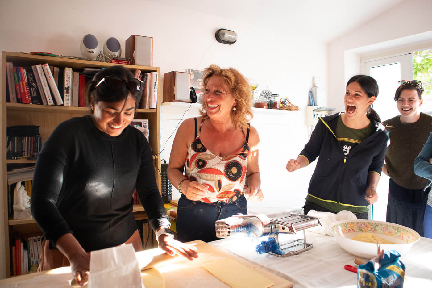 Women preparing food together at a table in a home kitchen