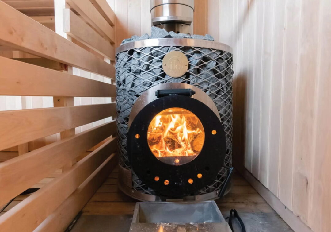 Sauna stove with open fire in a wooden sauna, UK style interior