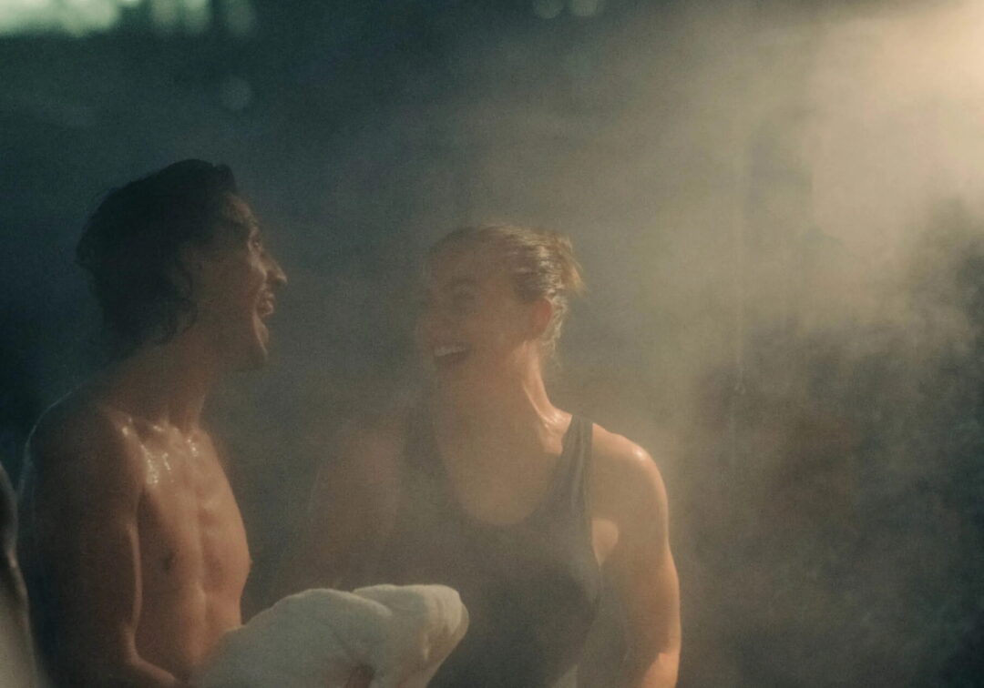 Women in a steamy sauna, relaxing together in warm steam and low light.