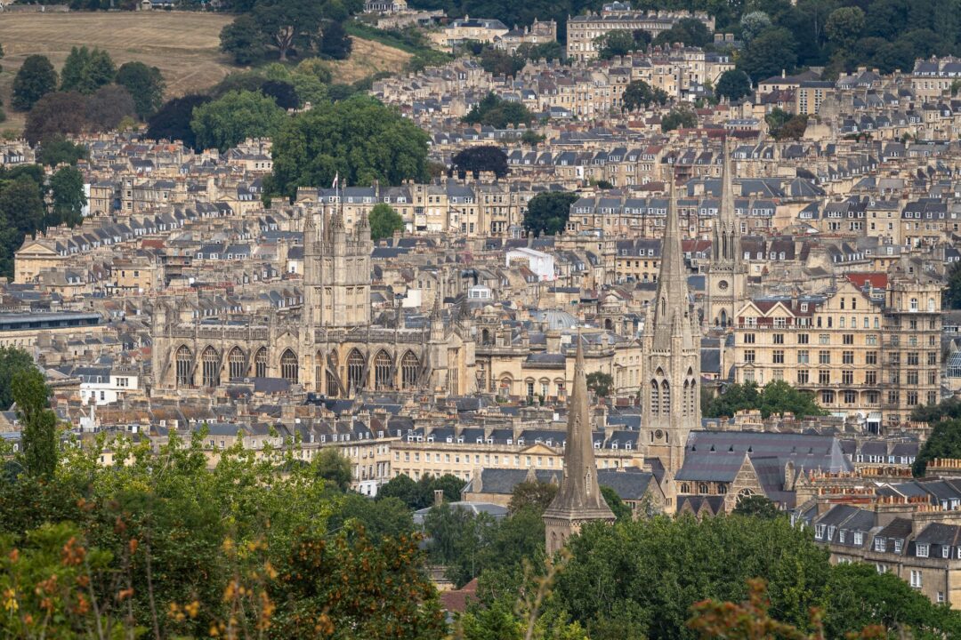 Bath Abbey and historic rooftops in Bath, Somerset, UK, viewed from above