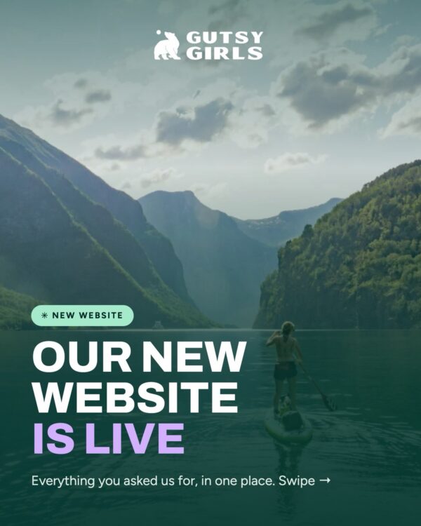 Gutsy Girls “Our new website is live” banner over a woman paddleboarding on a mountain lake