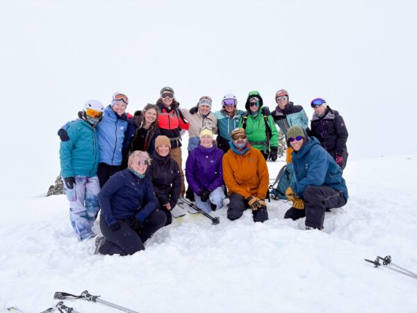 Women ski touring group portrait in snowy mountains, likely Norway during a winter adventure holiday