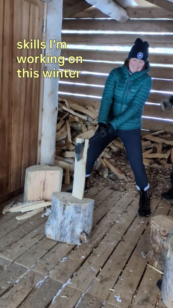 Woman building a fire pit inside a wooden shelter, with text “skills I’m working on this winter”