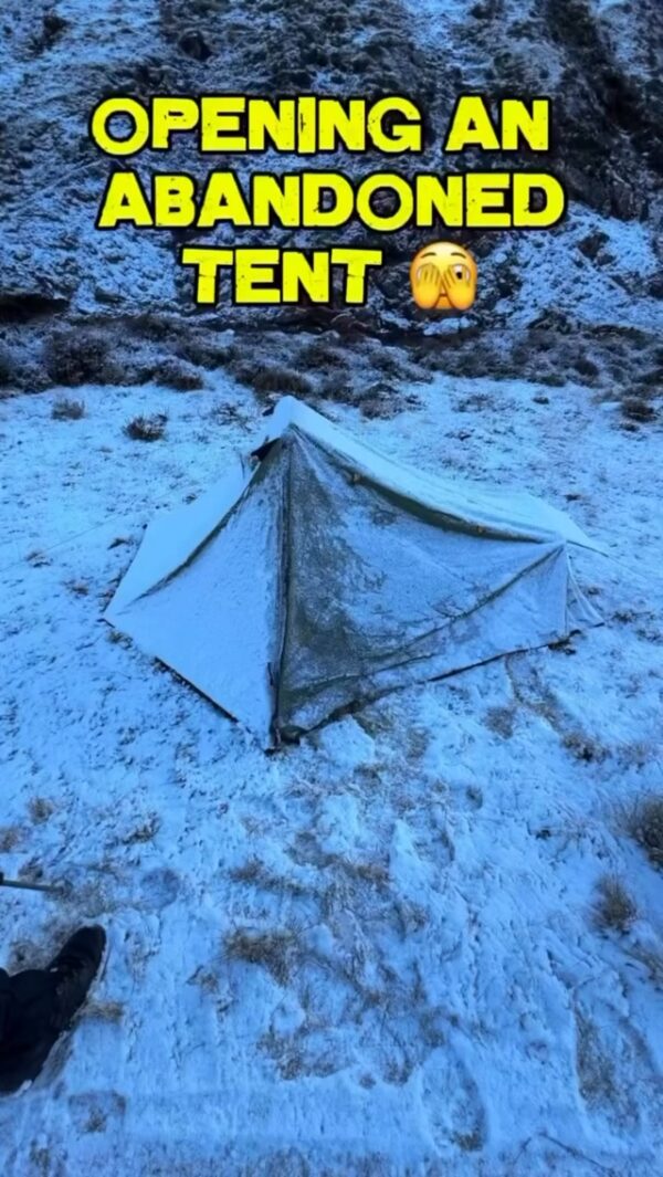 Opening an abandoned tent on a snowy hillside, with text “OPENING AN ABANDONED TENT” 😳