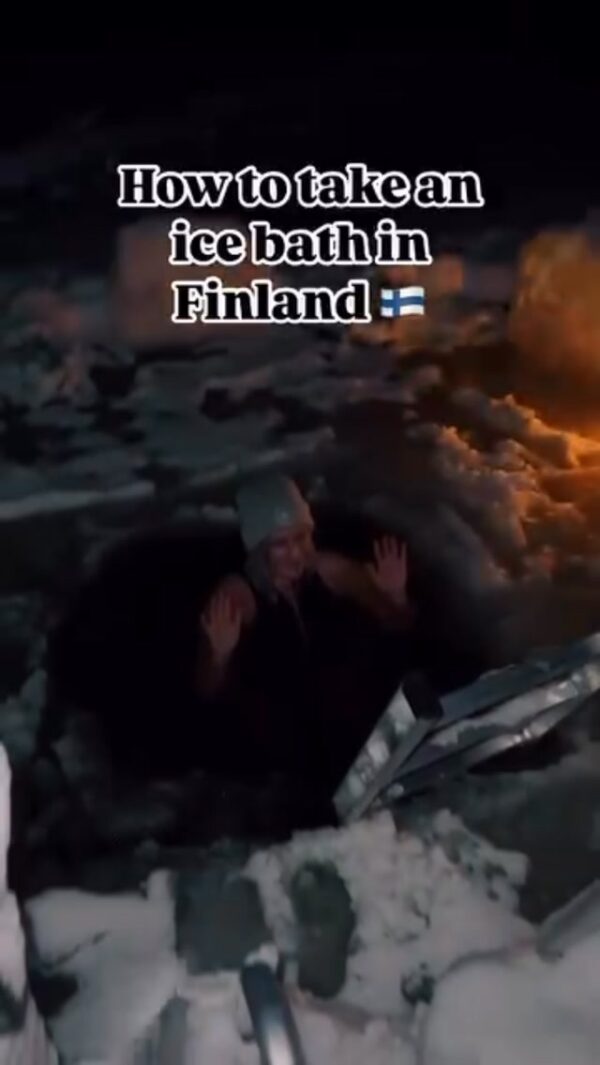 Women in an ice bath in Finland with on-screen text “How to take an ice bath in Finland”